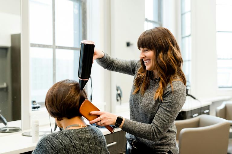 A barber cutting a clients hair.