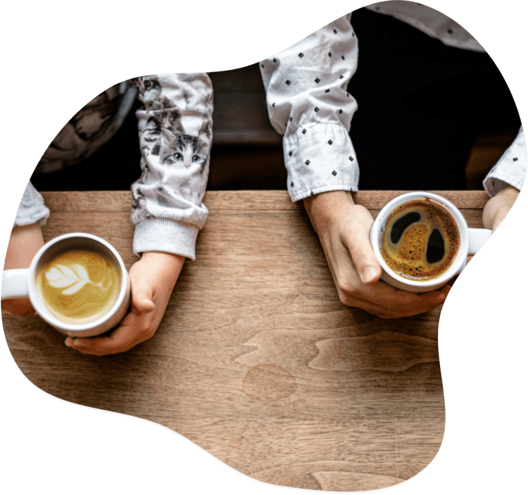 Two people holding coffee cups