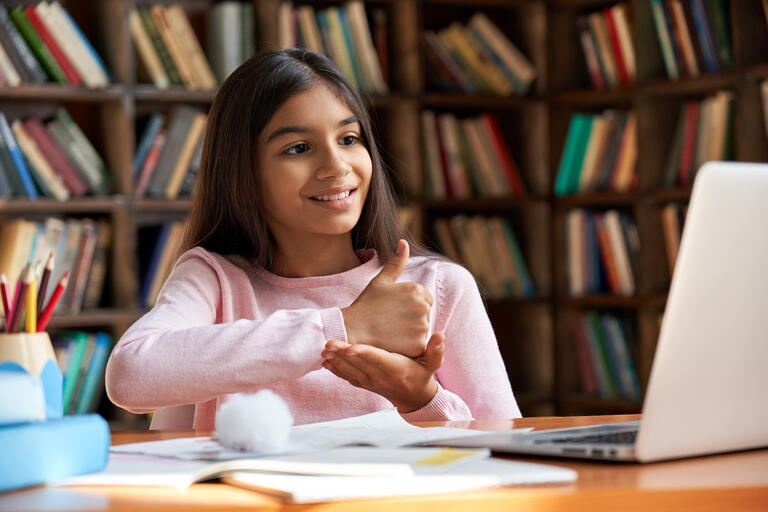 A girl rehearsing sign language.